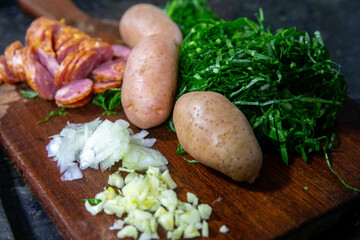 Traditional Portuguese green broth with potatoes, cabbage and chorizo ​​sausage ingredients