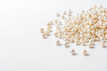 Close Up of Scattered Pearls on a White Background