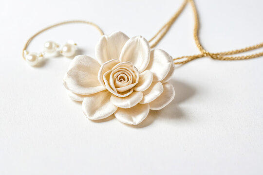 White Silk Flower with Pearl Necklace on White Background