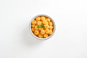 Bowl of Cheesy Puffs with a Garnish of Basil