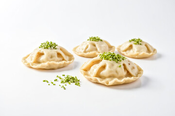 Four dumplings with green onions on a white background