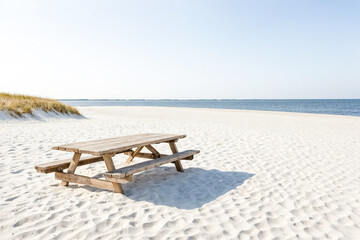 Fototapeta premium Wooden Picnic Table on a White Sandy Beach