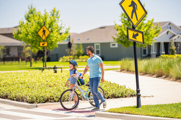 father and son on bicycle at fathers day. active father setting a example for fathers son. fathers parenting with son outdoor. childhood of son supported by fathers care. Cherishing moments