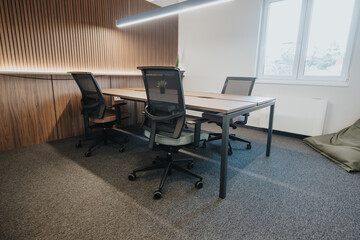 A contemporary office featuring sleek desks, ergonomic chairs, and wood paneling that creates a warm, productive environment.