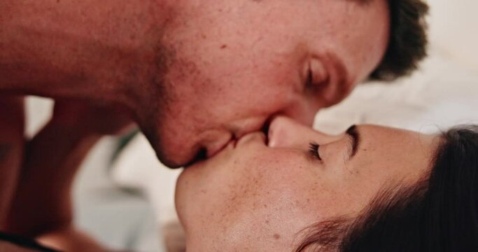 Couple, erotic and kiss on bed, sex and desire foreplay or romance touch for love in home. People, bedroom and lust bonding on valentines day for marriage, closeup and lovers for passion after date