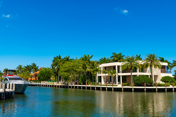 Travel to bay at Florida neighborhood. Summer vacation in tropical residential house. Luxury summer villa with yacht pier. Vacation in summer paradise. Luxury house at summertime. Traveling
