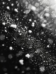 Snow falling on against a dark night background. 