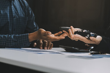 Car sales representative gives keys to new car owner, concept for car rental Focus on the key. Pick up the key. Close-up of the key transfer from the new machine to the buyer.