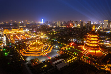 Illuminated Cityscape with Ancient Pagodas at Night