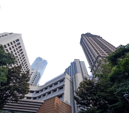 A stunning view of a skyscraper against a clear blue sky, captured from a low angle, showcasing the architectural magnificence and modern urban design.