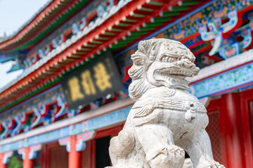 Ancient Stone Lion Guarding Colorful Temple