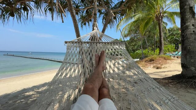 Relaxing in a hammock on the beach in Bang Tao, Phuket, Thailand