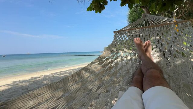 Relaxing in a hammock on the beach in Bang Tao, Phuket, Thailand