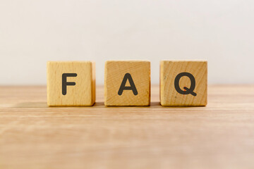 Frequently asked questions or FAQ written on wooden blocks