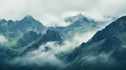 Fototapeta premium a misty mountain range shrouded in a veil of clouds,