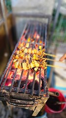 Famous street food in Thailand, grilled squid on charcoal stove, grilled food, street food, food stall, travel in Thailand