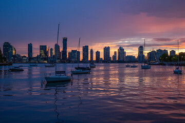 city skyline with boats at sunset