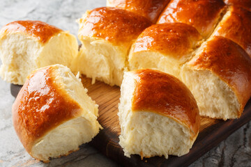 Sweet Hawaiian Bread Rolls for sandwiches, or just to snack on on their own closeup on the wooden...