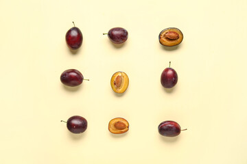 Fresh ripe plums on yellow background