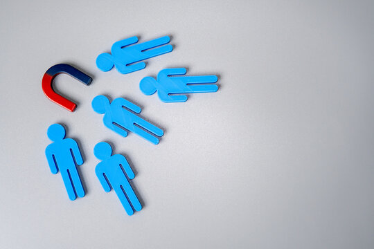 Magnet attracts human figure. Customer acquisition and customer retention concept