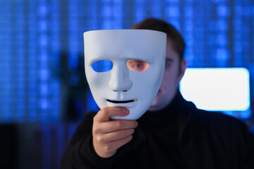 Hacker with mask in dark room, closeup