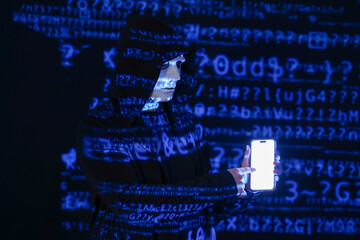 Hacker with mobile phone and projection of programming code on dark background