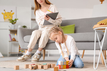 Little girl playing with cubes at psychologist's office