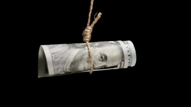 A Hundred-Dollar Bill Hanging On A Rope, Concept Of Dependence On Money, Limitation Of Freedom, Slavery.