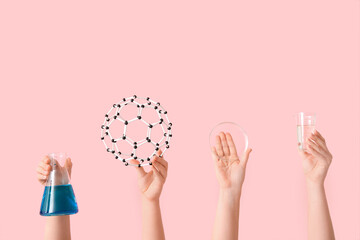 Female hands holding filled flask with molecular model, Petri dish and measuring cup on pink...