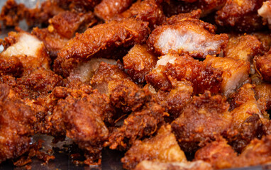 A plate of fried chicken pieces with a lot of seasoning