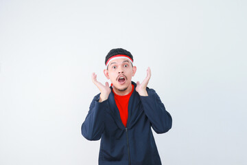 Shocked young Asian man in casual t-shirt isolated on white background. indonesian independence day celebration concept