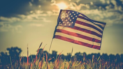 An American flag waves proudly against a cloudy sky, bathed in the warm glow of the setting sun.