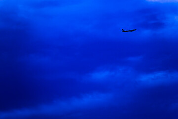 A blue sky with a plane flying through it