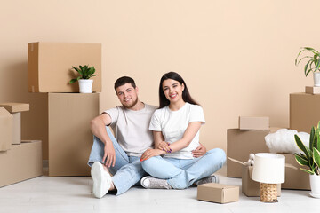 Young happy couple near belongings in their new house