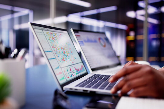 African American woman using virtual dashboard to predict emerging market trends