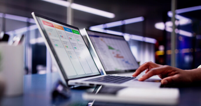 Focused African American woman using laptop to manage business schedule