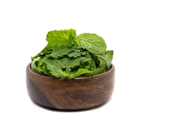 Raw Mint Leaves or Pudina Leaves in a Wooden Bowl Isolate on White Background with Copy Space