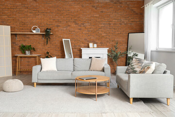 Interior of living room with sofas, fireplace and mirrors