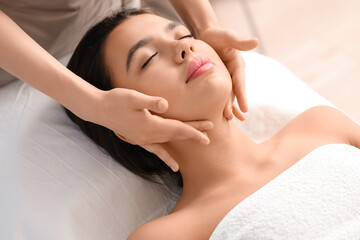 Fototapeta premium Young woman getting facial massage in salon, closeup