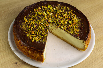 Homemade pistachio cheesecake dipped in dark chocolate
