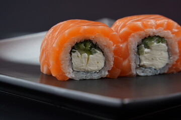 Philadelphia Sushi Rolls with Salmon and Cream Cheese on a black background