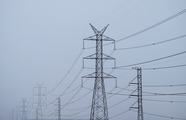 High voltage poles and long power lines in Thailand