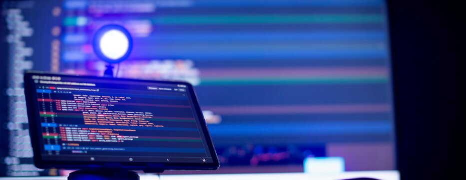 Work from home. Programmer coding code on notebook screen at home.