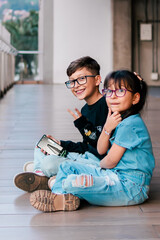 Latino children playing, running and jumping on a high floor very happily. Siblings, vacations and family. Children day.