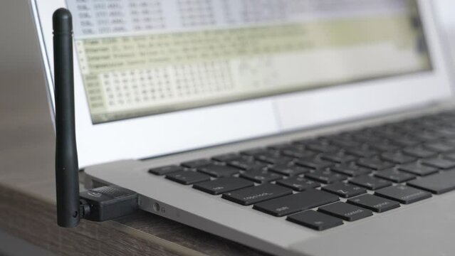 A laptop screen shows a lot of numbers and letters. The laptop is open to a page with a lot of information