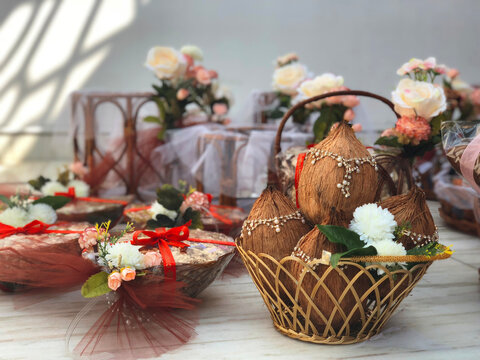 decorated coconut kept in a basket with flowers and other decorated baskets essential in Hindu puja as a part of wedding Trousseau