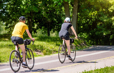 Naklejka premium Cyclists ride on the bike path in the city Park 