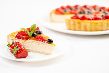 A piece of Delicious and appetizing cheesecake with strawberries and blueberries on a white background .Menu for restaurant and cafe.