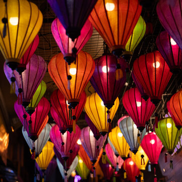 colorful traditional silk lanterns shining in the dark in Hoi An, Vietnam