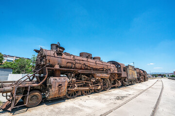 Steam locomotive in very bad condition, completely rusty and abandoned on the unused tracks at Uşak Rail way station.